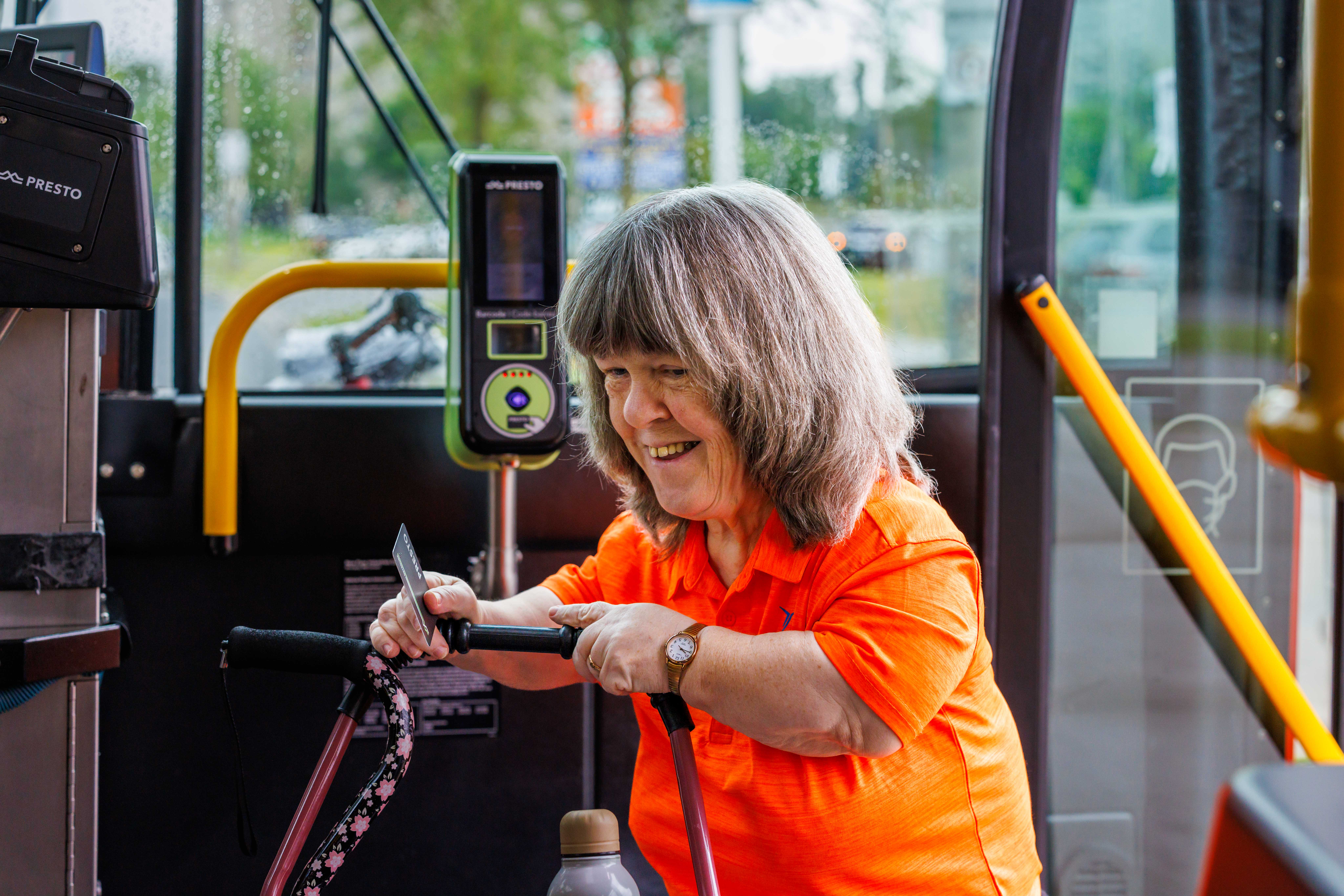 Person in orange shirt on the bus.